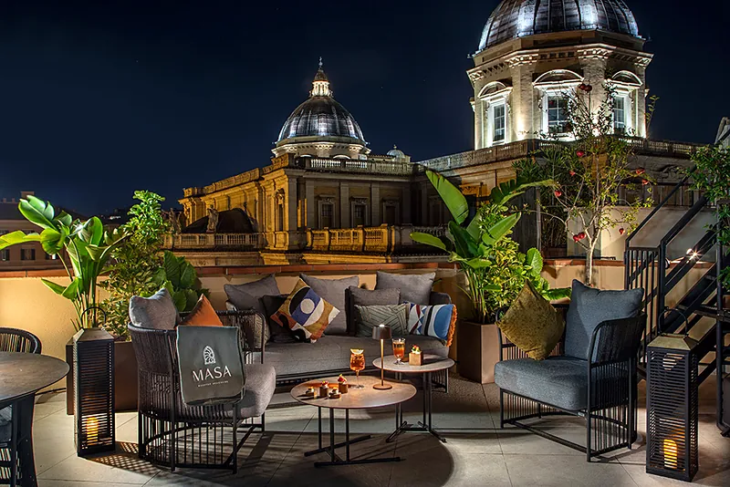 Il salotto all'aperto di Masa Roof Top di sera, sotto le cupole di Santa Maria Maggiore